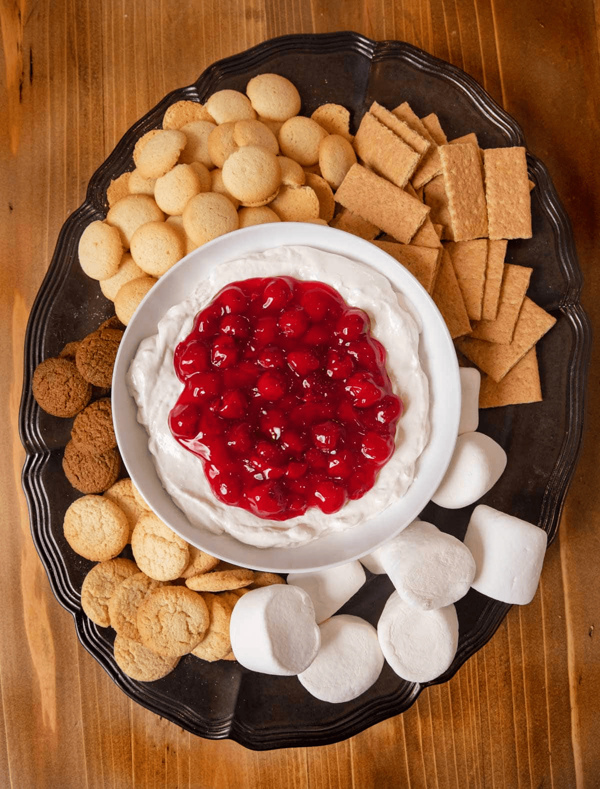 Cherry dip from above with crackers and cookies on a serving platter