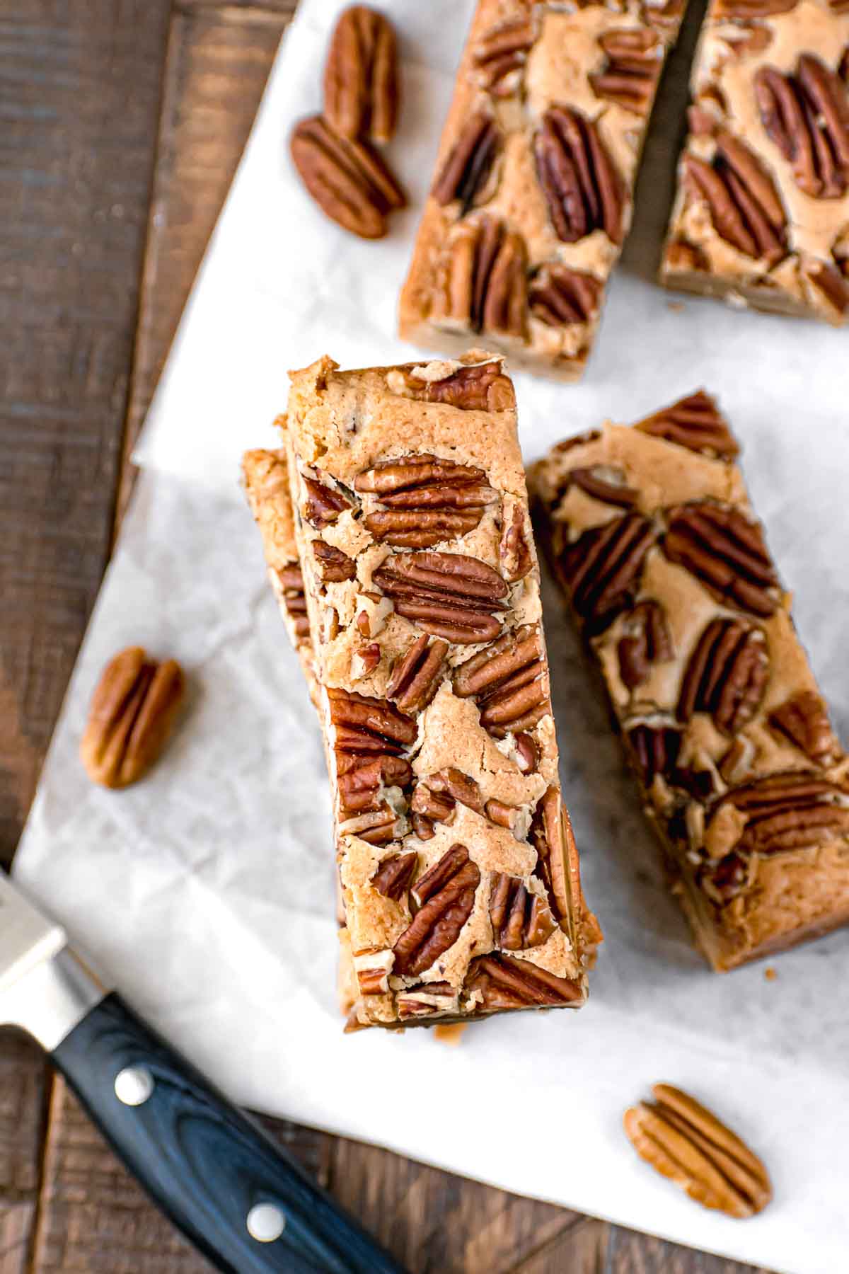 Maple Pecan Bars sliced and served on white parchment paper.