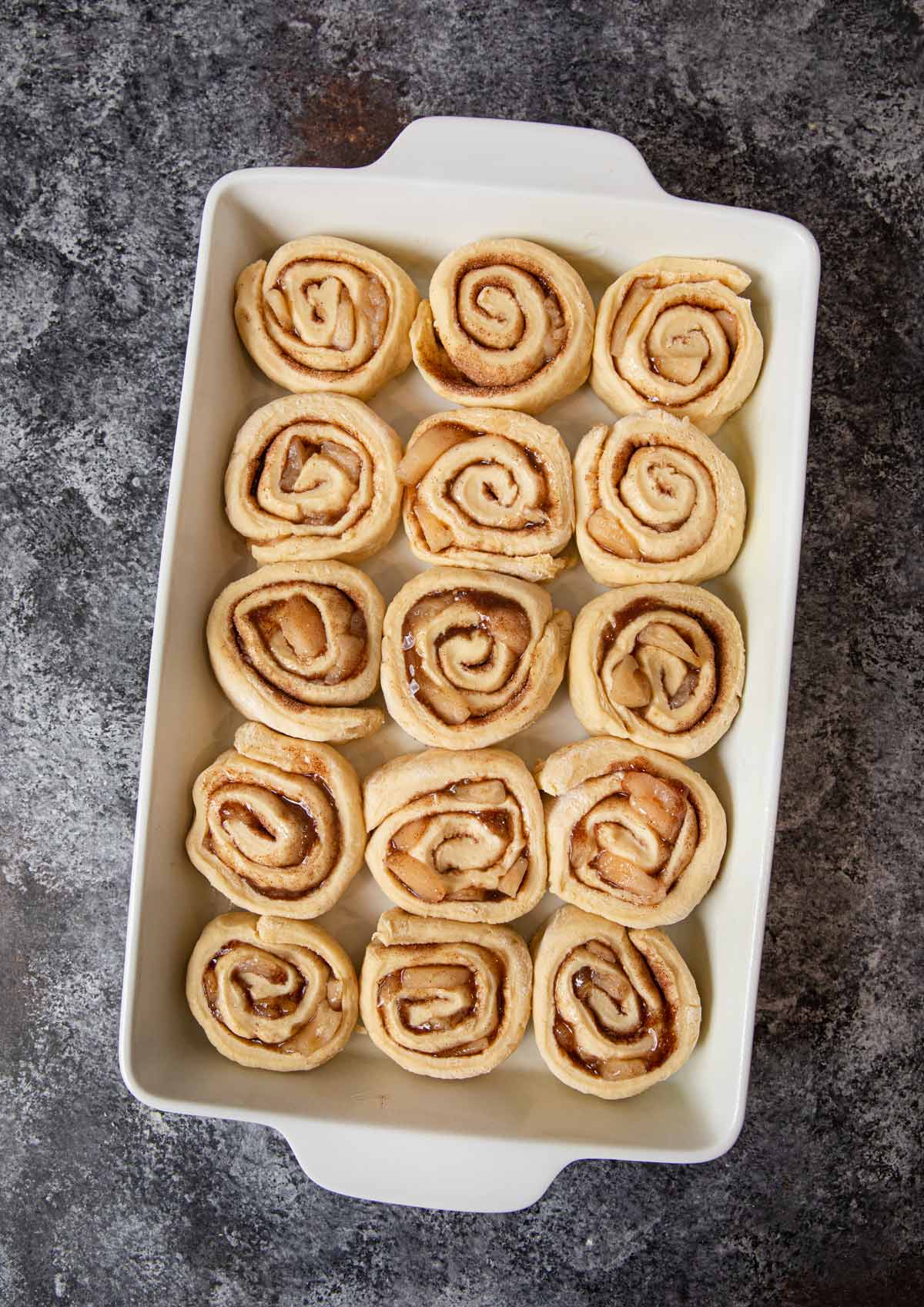 Apple Crisp Cinnamon Rolls in baking dish before proofing