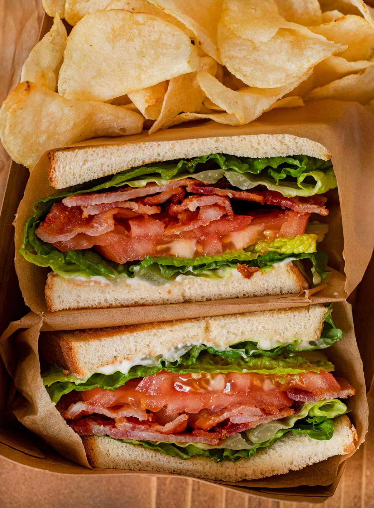 BLT Sandwich sliced in half with chips