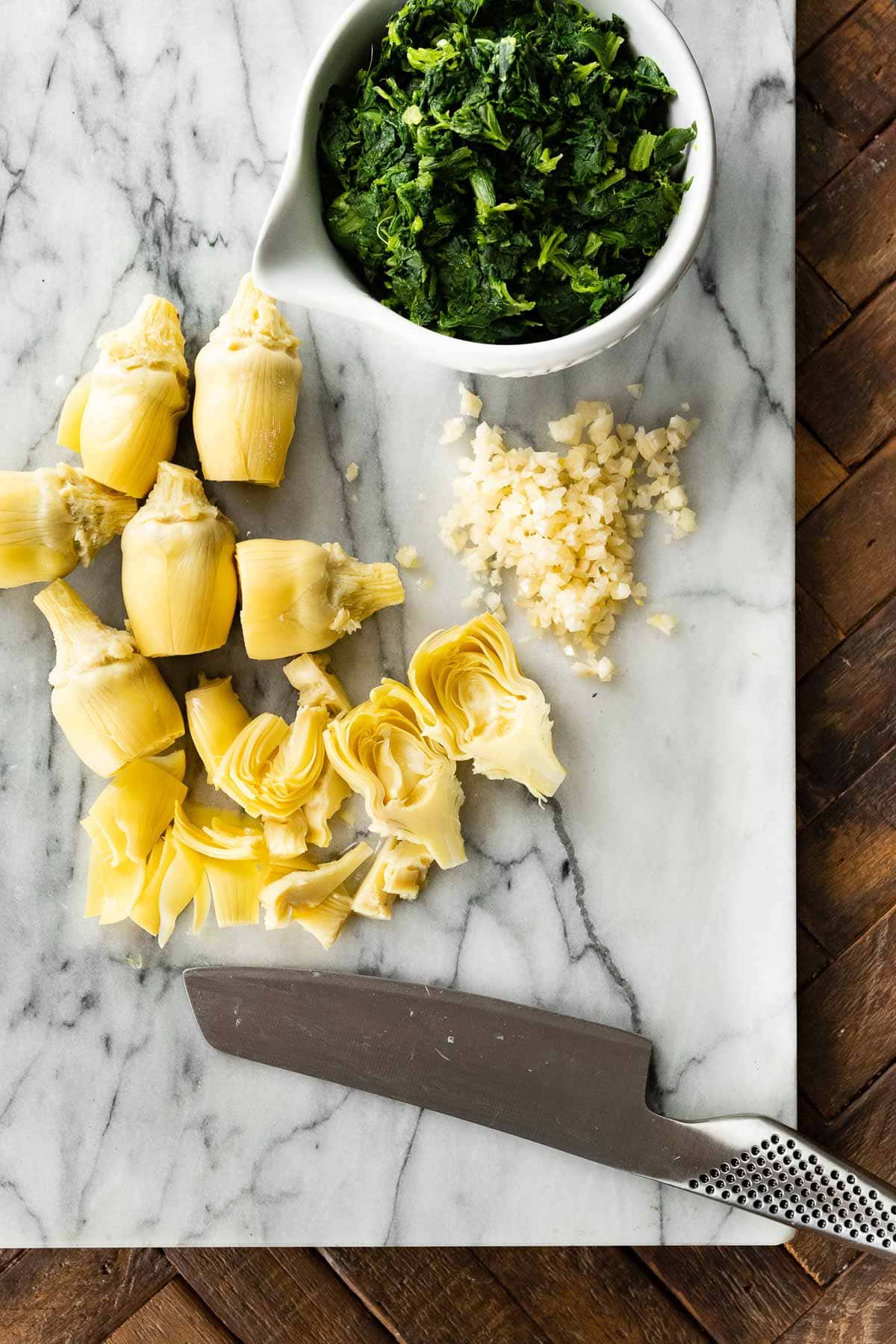 Artichokes on cutting board for Baked Spinach Artichoke Chicken