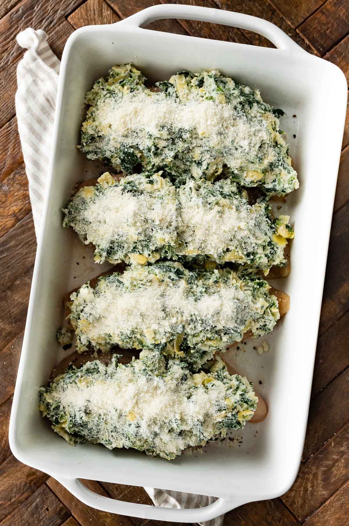 Baked Spinach Artichoke Chicken in baking dish before baking