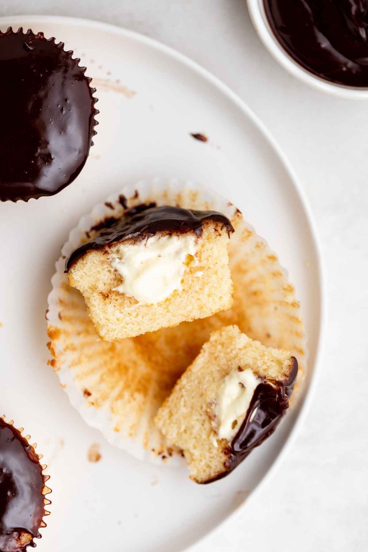 Boston Cream Cupcake cut in half to expose cream filling