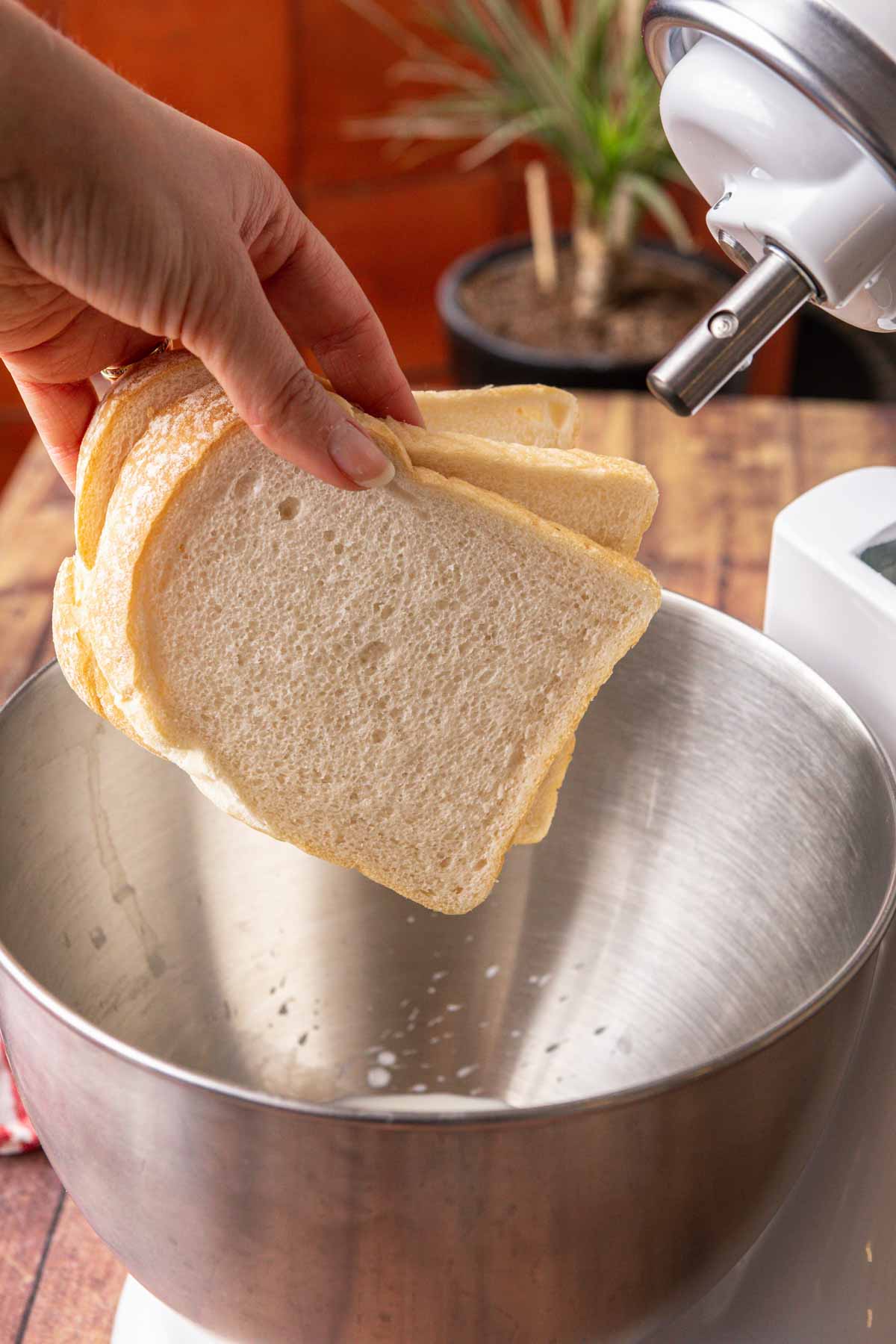 adding bread to stand mixer