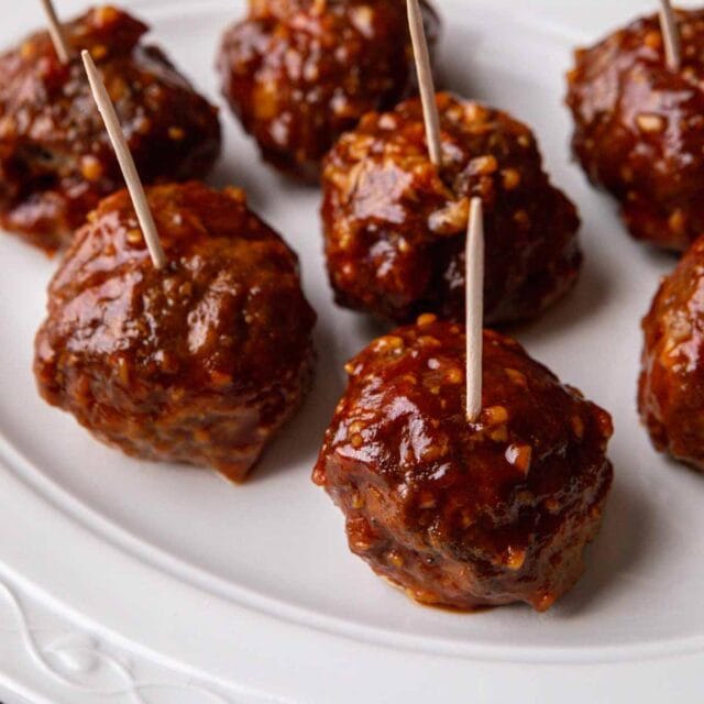top view of meatballs on a plate with toothpicks for grabbing