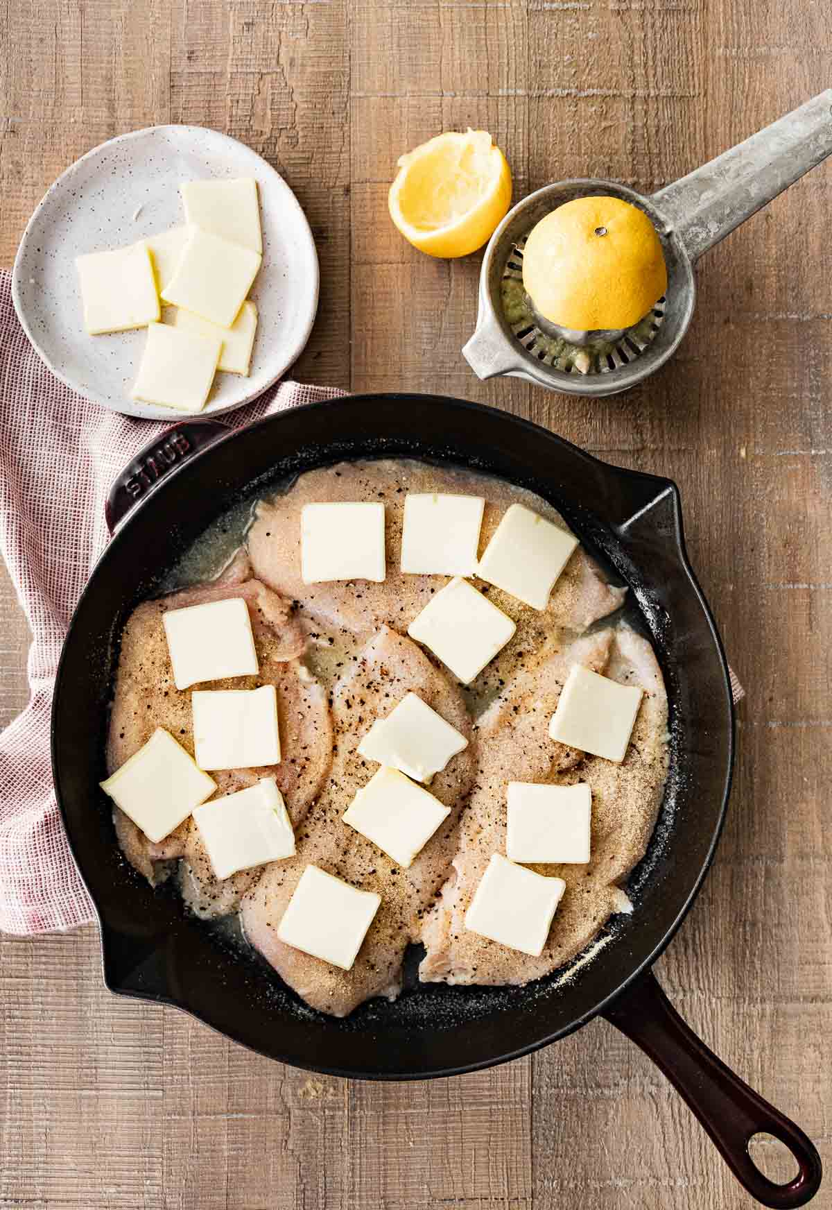 Buttery Lemon Garlic Baked Chicken in pan with butter