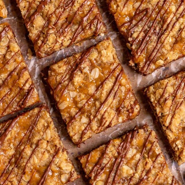 Caramel Chocolate Bars sliced on parchment drizzled with chocolate