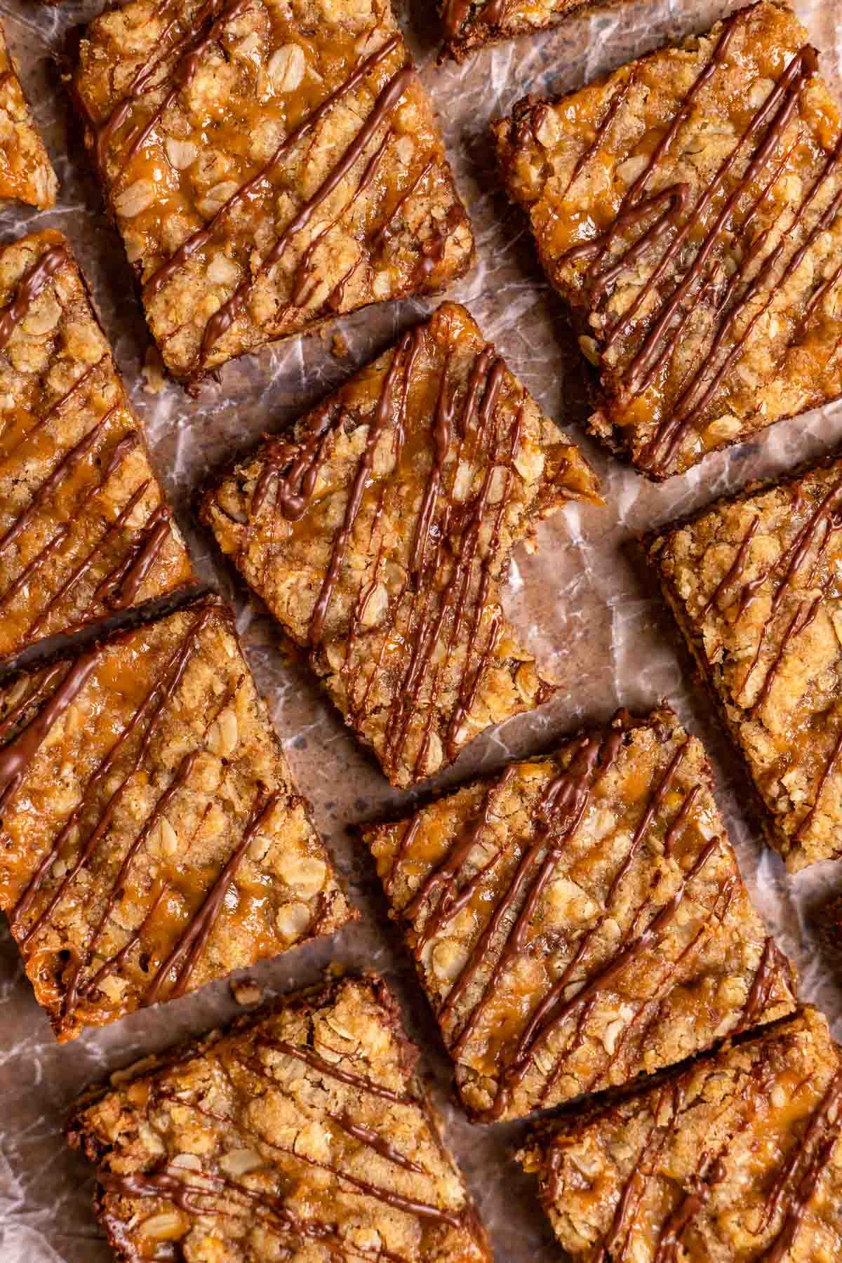 Caramel Chocolate Bars sliced on parchment drizzled with chocolate