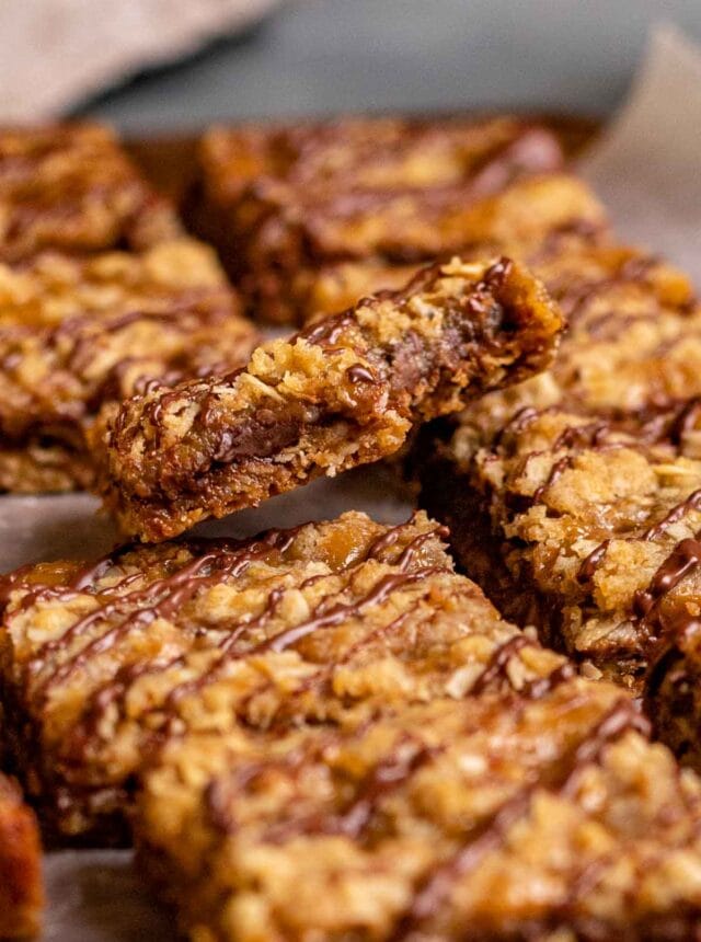 Caramel Chocolate Bars sliced on parchment drizzled with chocolate