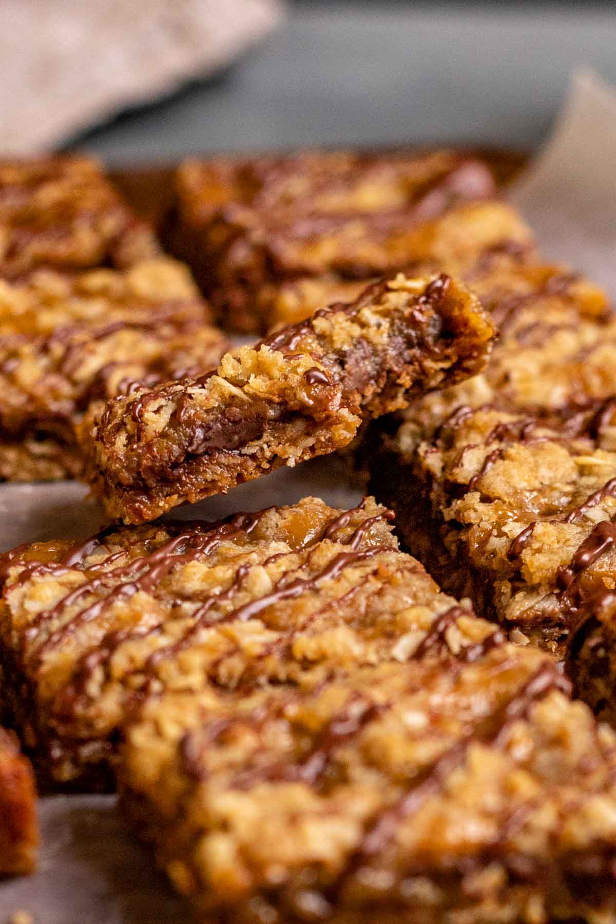 Caramel Chocolate Bars sliced on parchment drizzled with chocolate