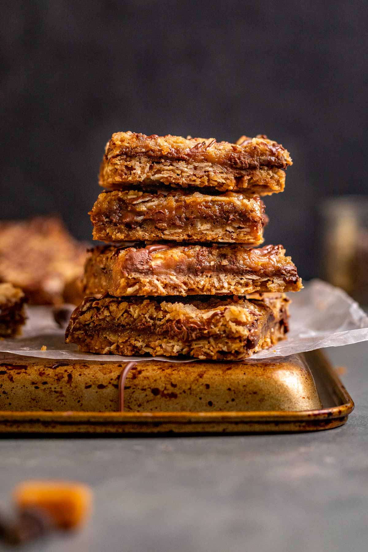 Caramel Chocolate Bars sliced and stacked on parchment