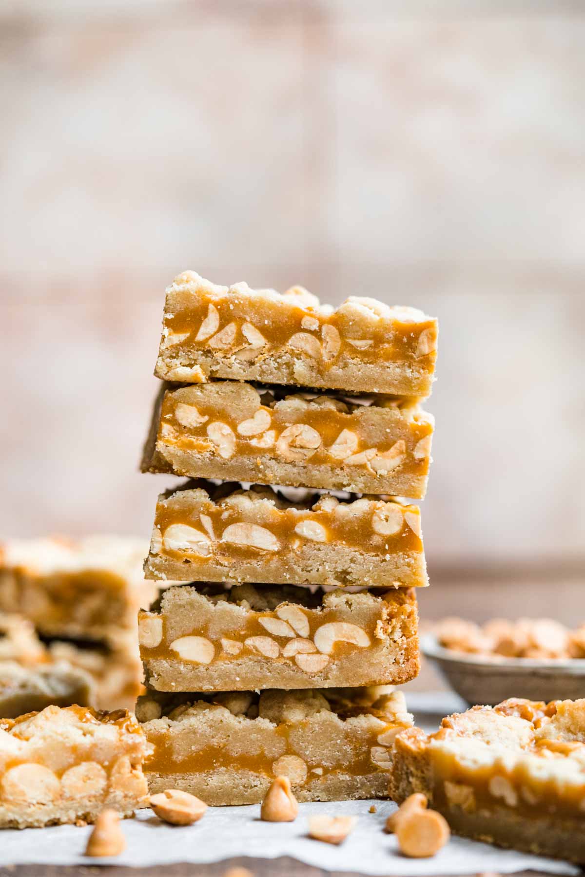 Chewy Peanut Shortbread Bars squares cut and stacked on parchment