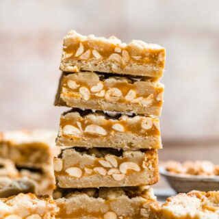 Chewy Peanut Shortbread Bars squares cut and stacked on parchment