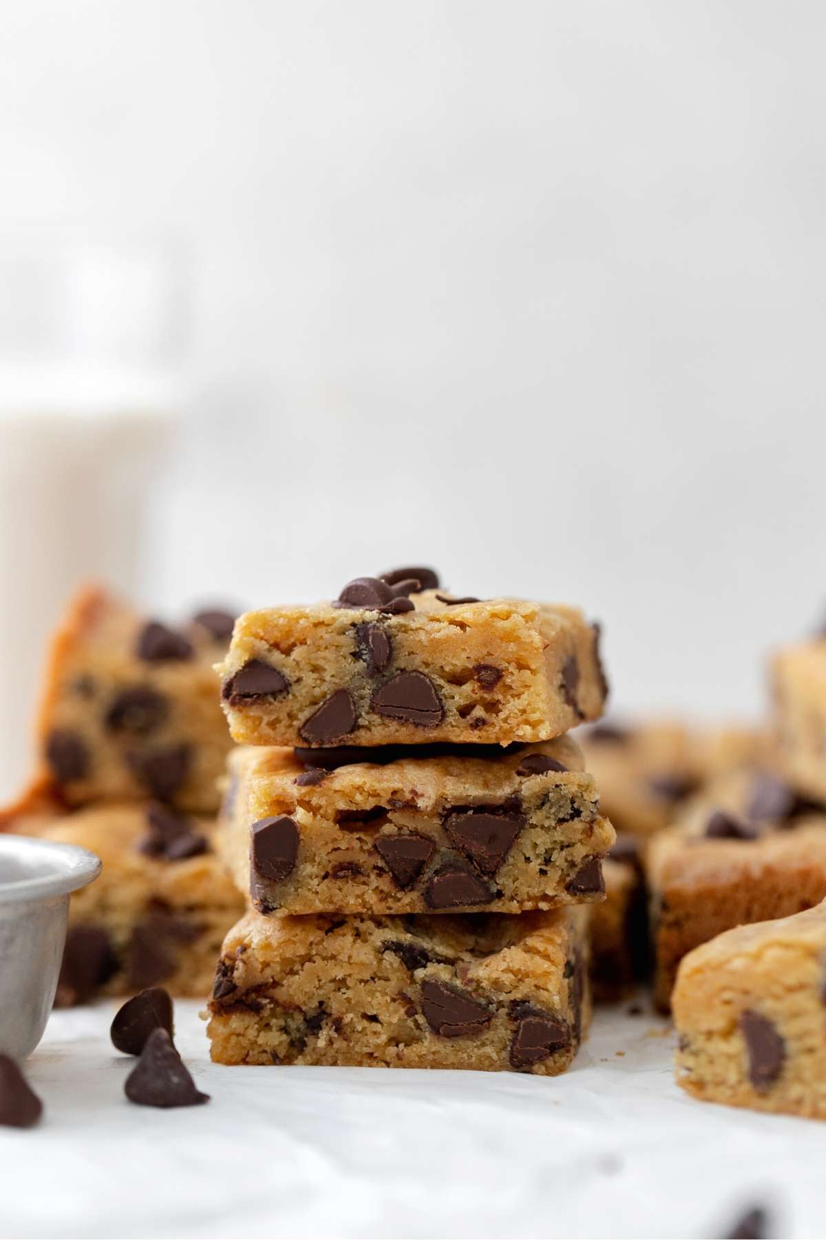 Stack of blondies with glass of milk in the background