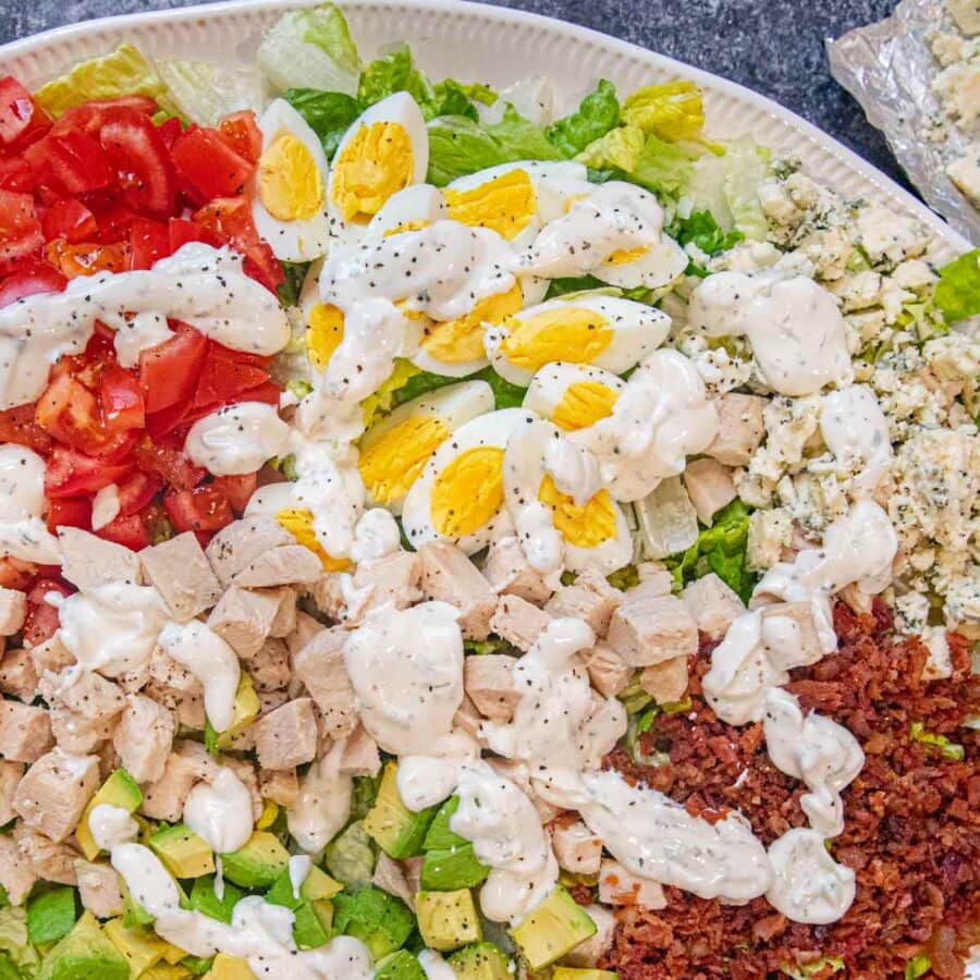 Cobb Salad on serving plate with dressing