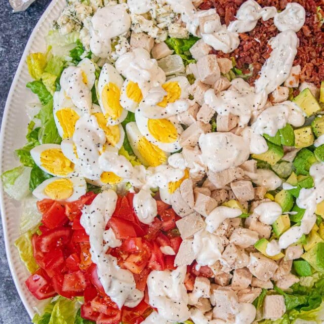 Cobb Salad on serving plate with dressing