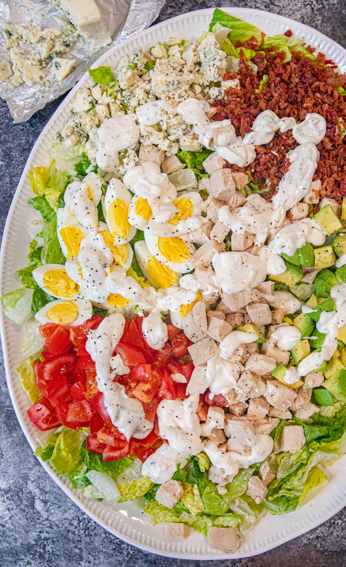 Cobb Salad on serving plate with dressing