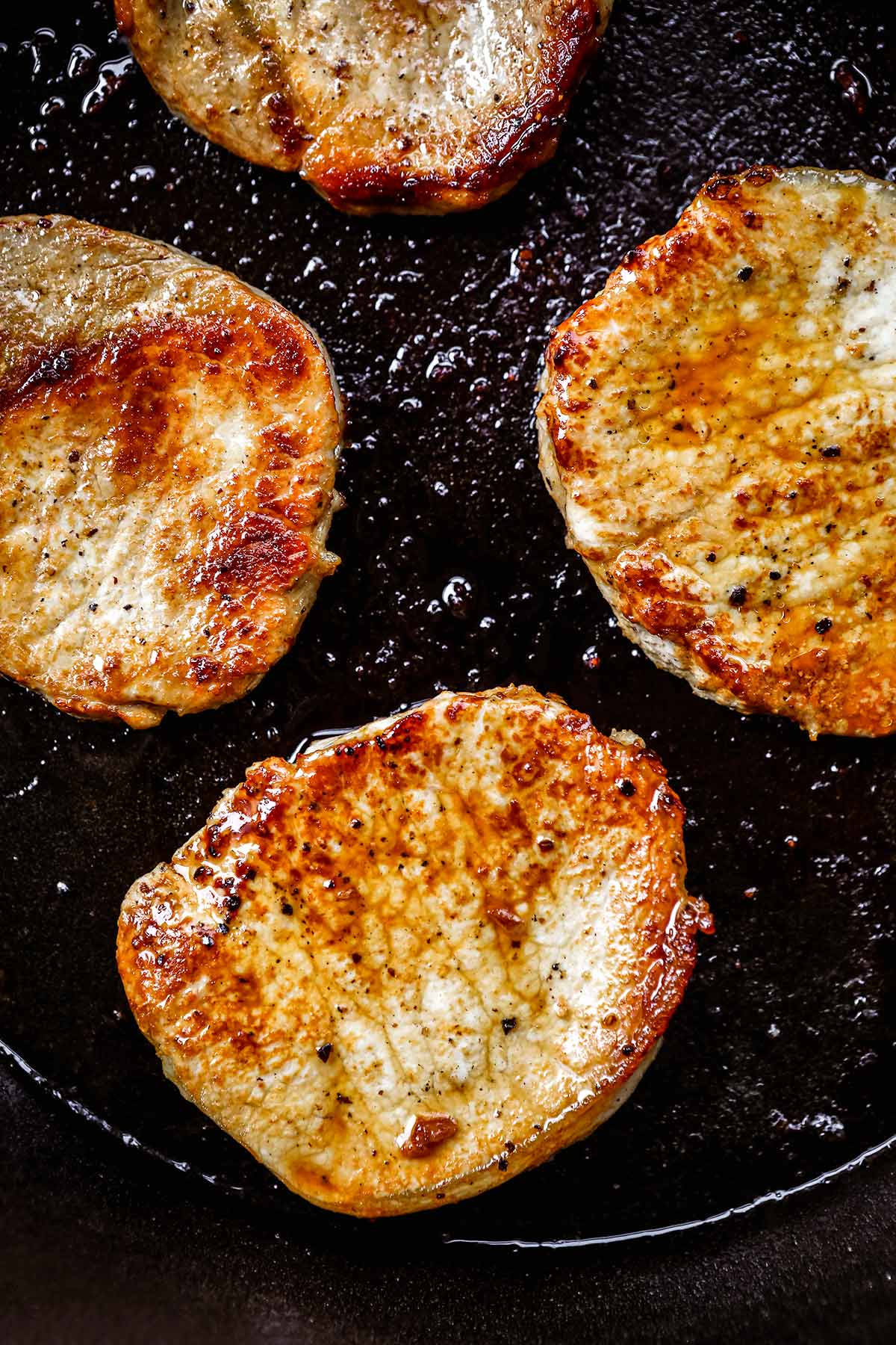 Hawiian Pork Chops seared in cast iron pan