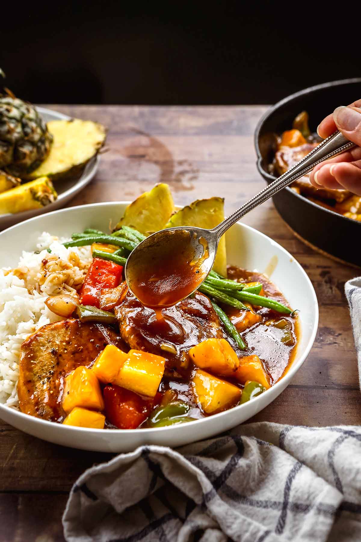 Hawiian Pork Chops served over rice with pineapples, onions, and bell peppers