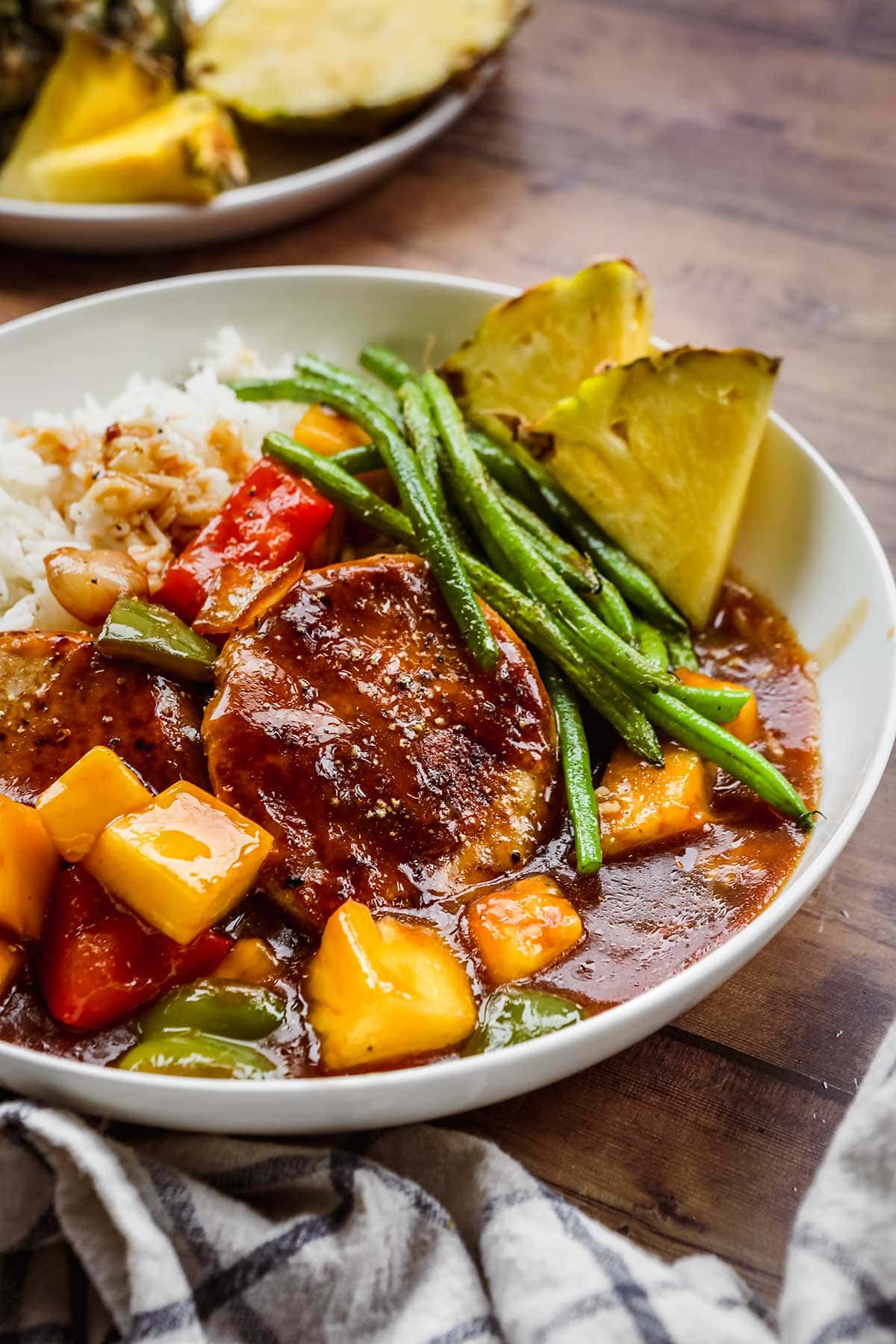 Hawiian Pork Chops served over rice with pineapples, onions, and bell peppers