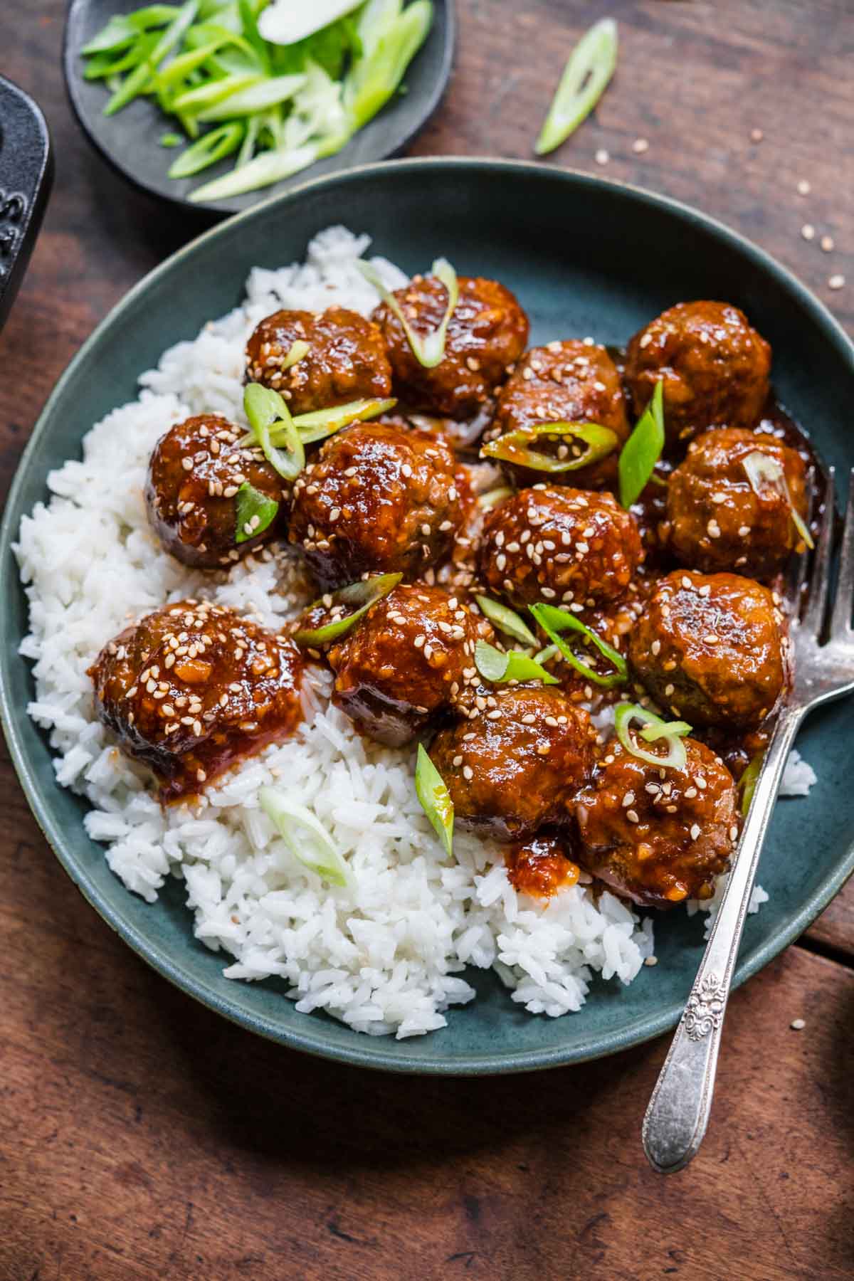 Honey Garlic Meatballs closeup served over rice with fork