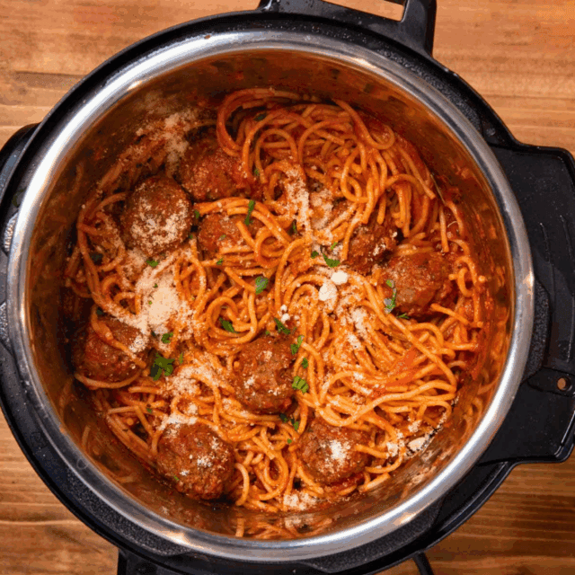 cooked pasta and rounded protein balls in cooker