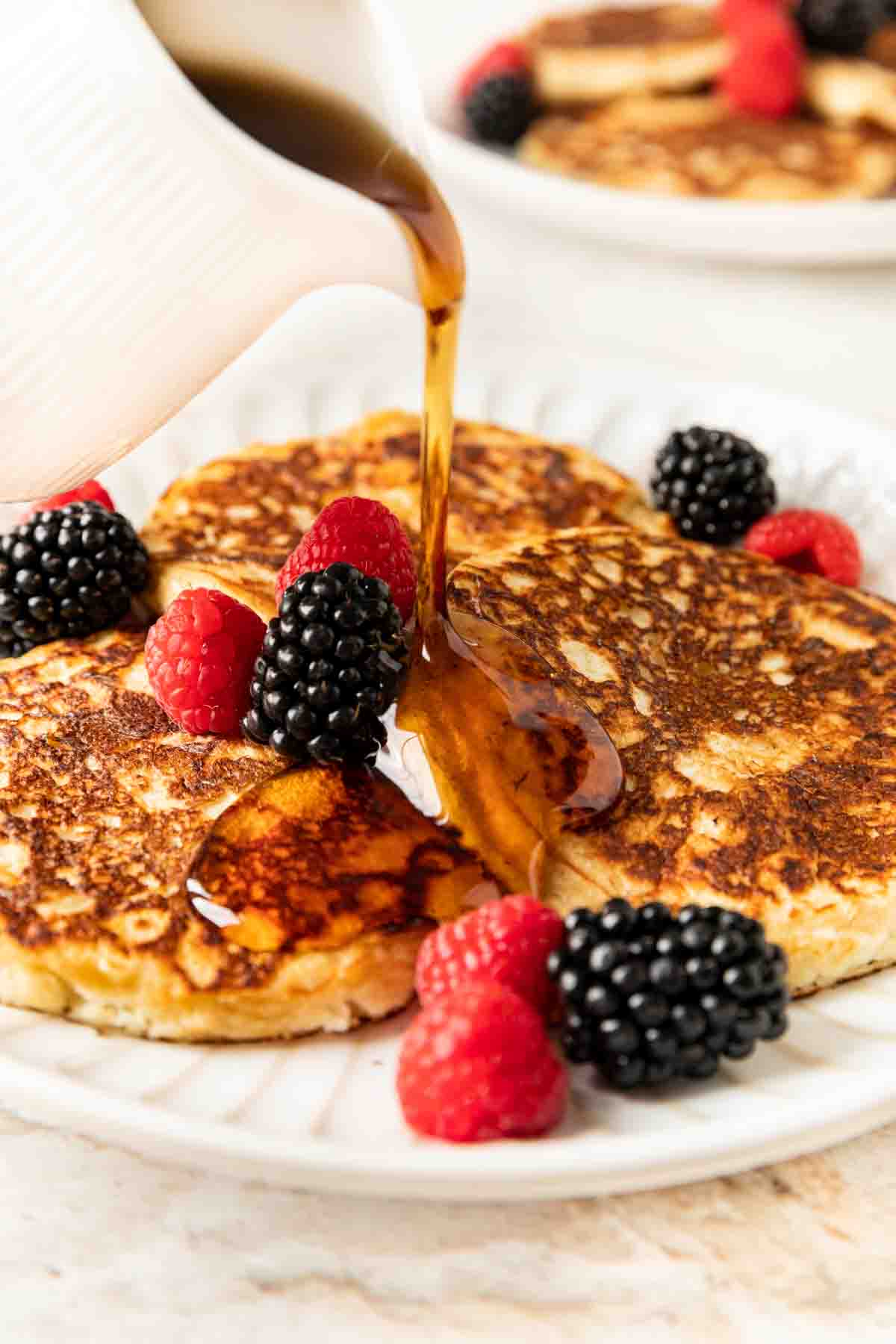 Overnight Pancakes ingredientsOvernight Pancakes ingredientsOvernight Pancakes stacked with fresh berries and maple syrup