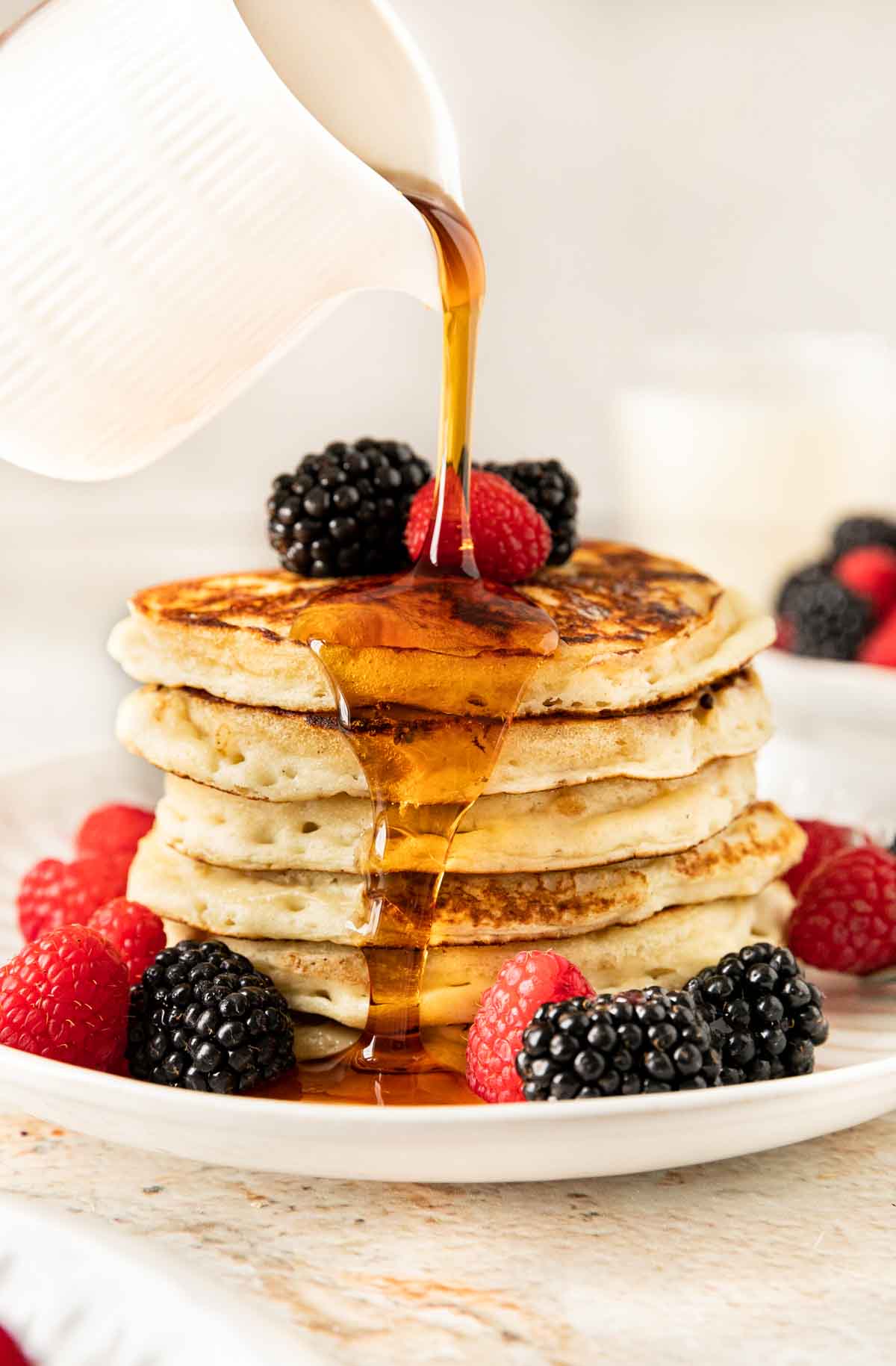 Overnight Pancakes ingredientsOvernight Pancakes ingredientsOvernight Pancakes stacked with fresh berries and maple syrup