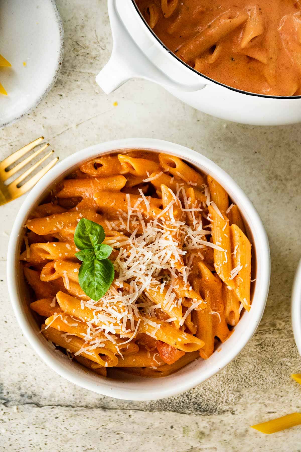 Pink Sauce Pasta in bowl with parmesan and basil garnish