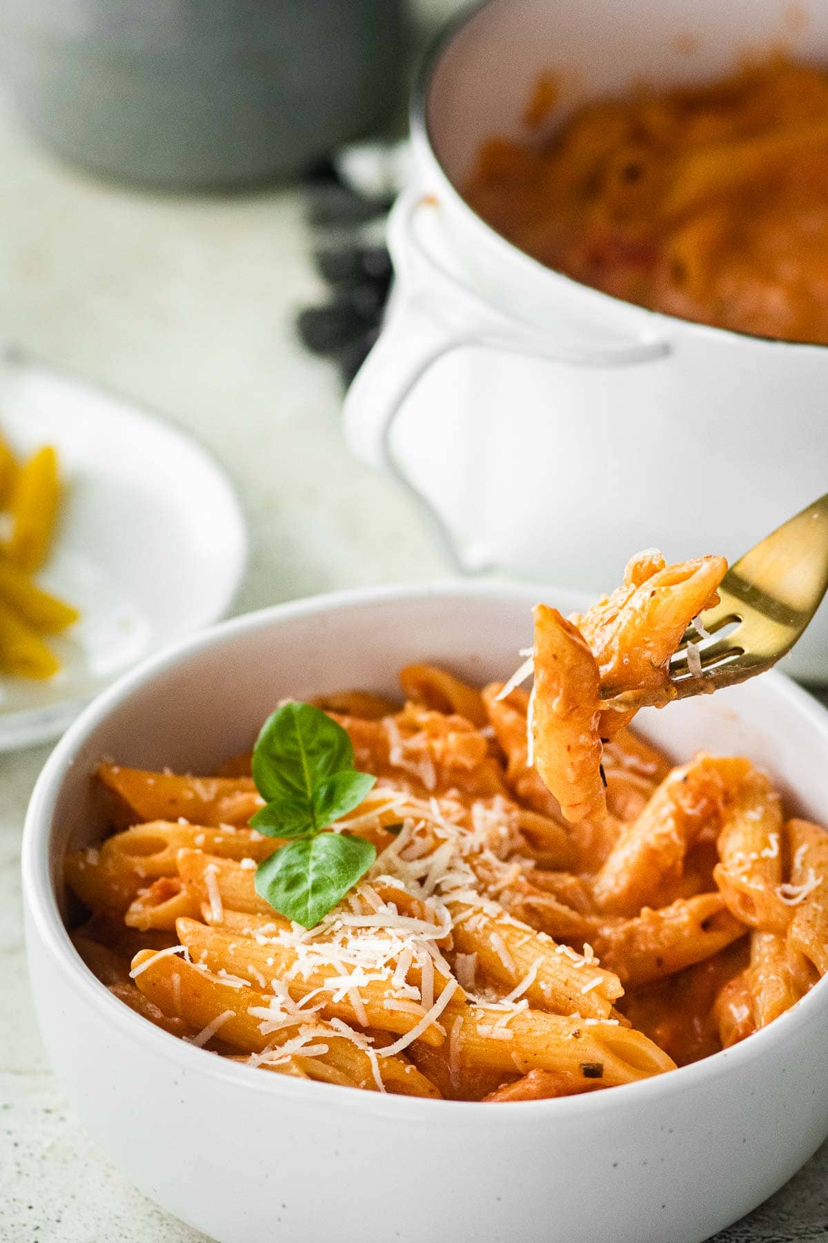 Pink Sauce Pasta in bowl with parmesan and basil garnish