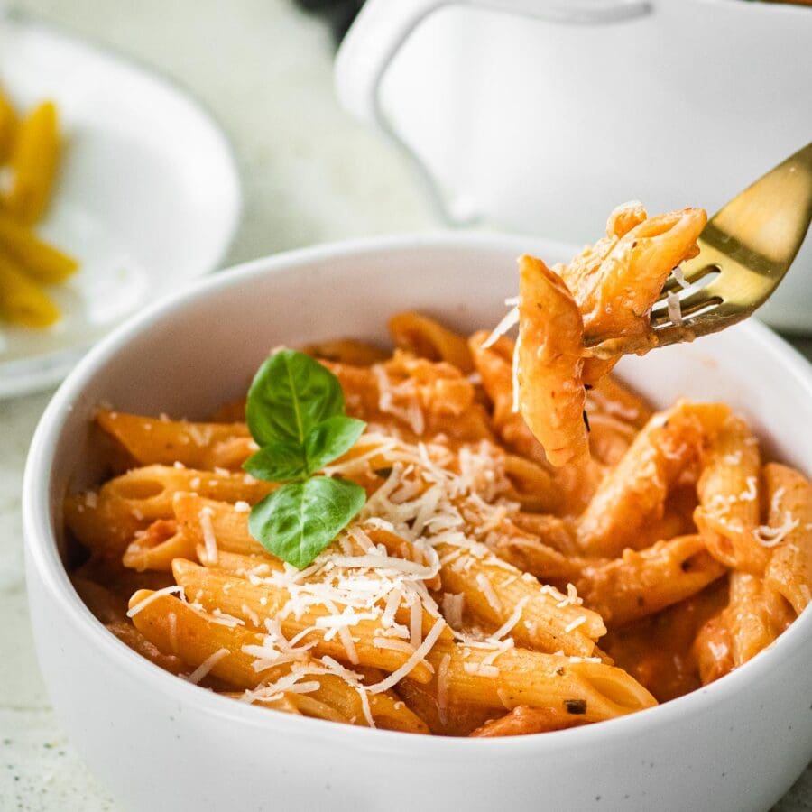 Pink Sauce Pasta in bowl with parmesan and basil garnish