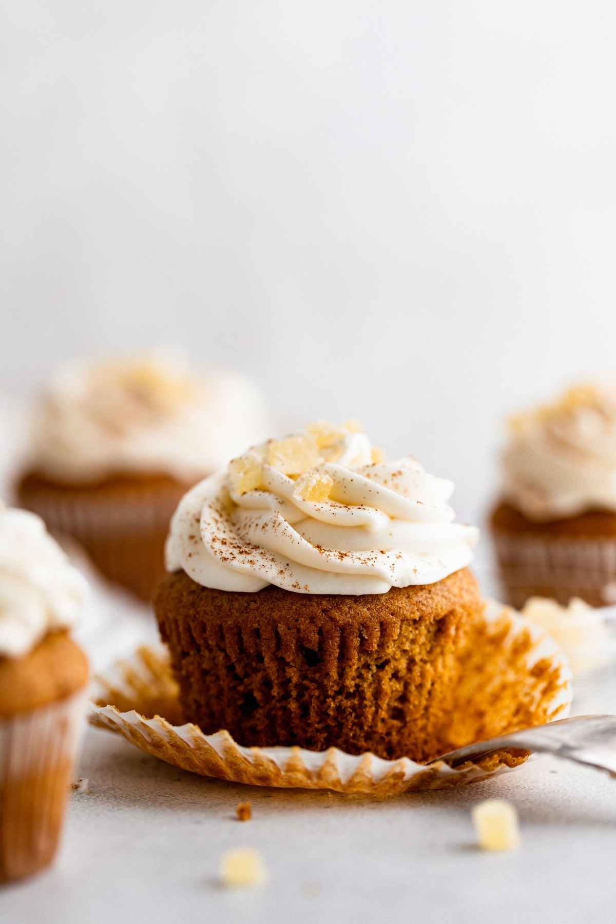 Pumpkin Ginger Cupcakes with cream cheese frosting swirl and candied ginger garnish