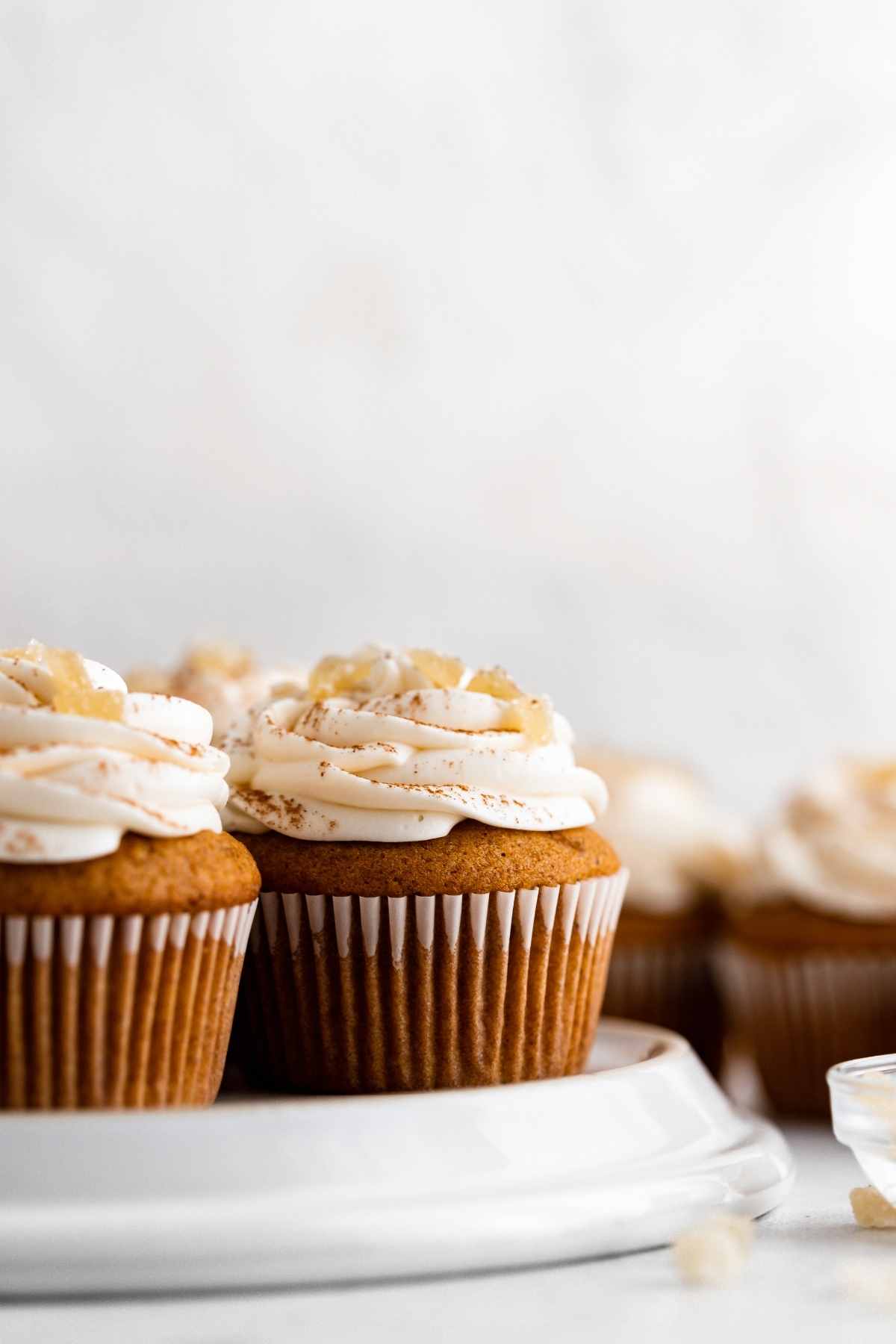 Pumpkin Ginger Cupcakes with cream cheese frosting swirl and candied ginger garnish