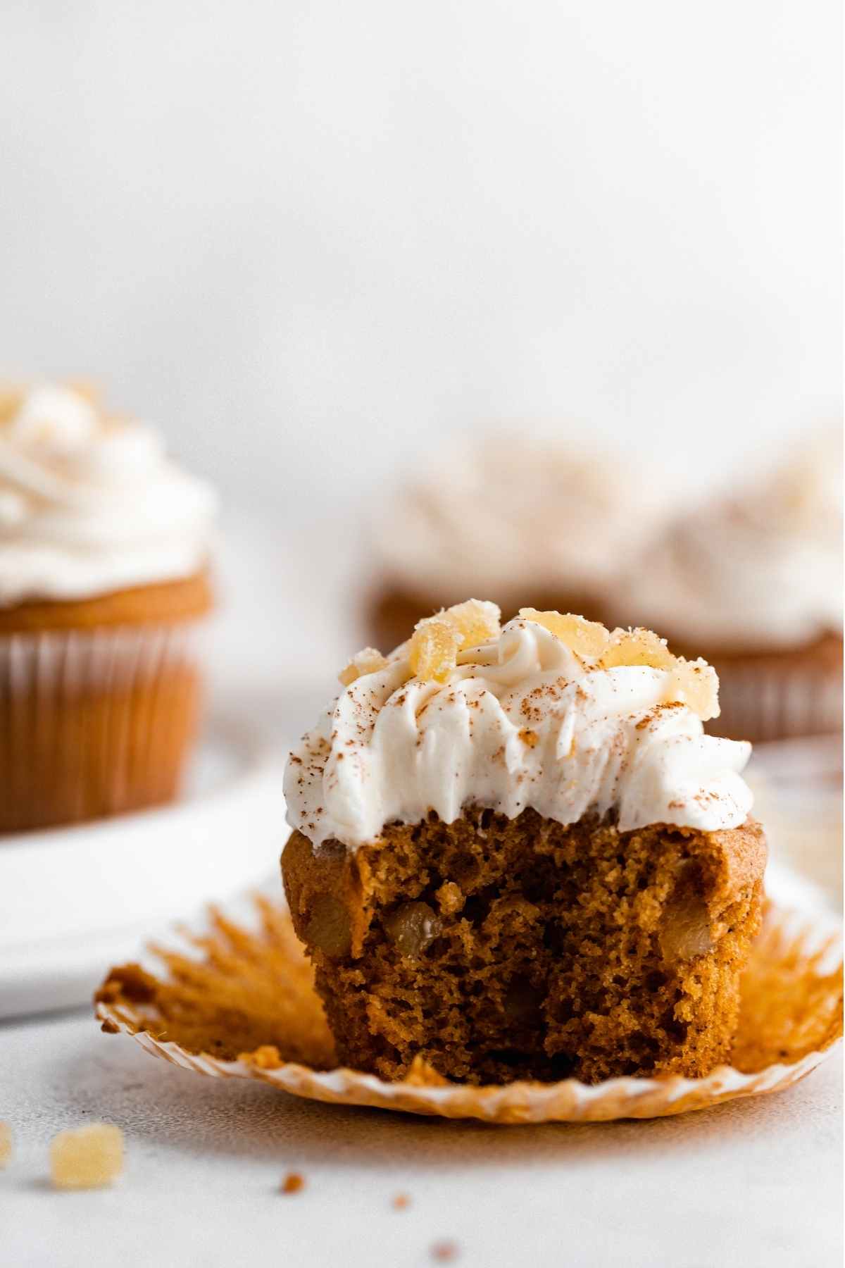 Pumpkin Ginger Cupcakes with cream cheese frosting swirl and candied ginger garnish