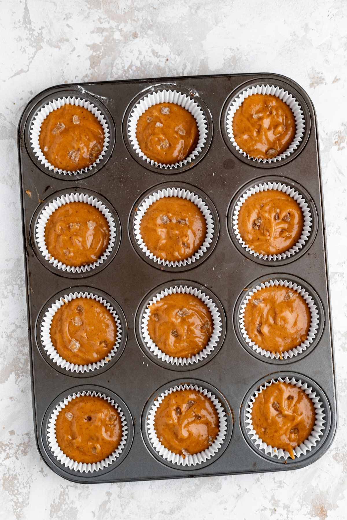 Pumpkin Ginger Cupcakes batter in cupcake pan before baking