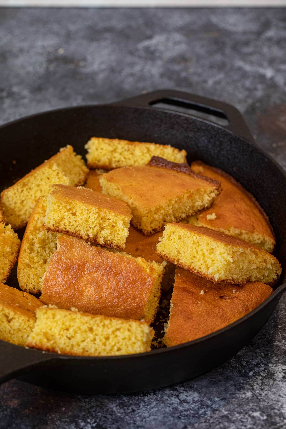 Skillet Cornbread sliced squares in cast iron skillet