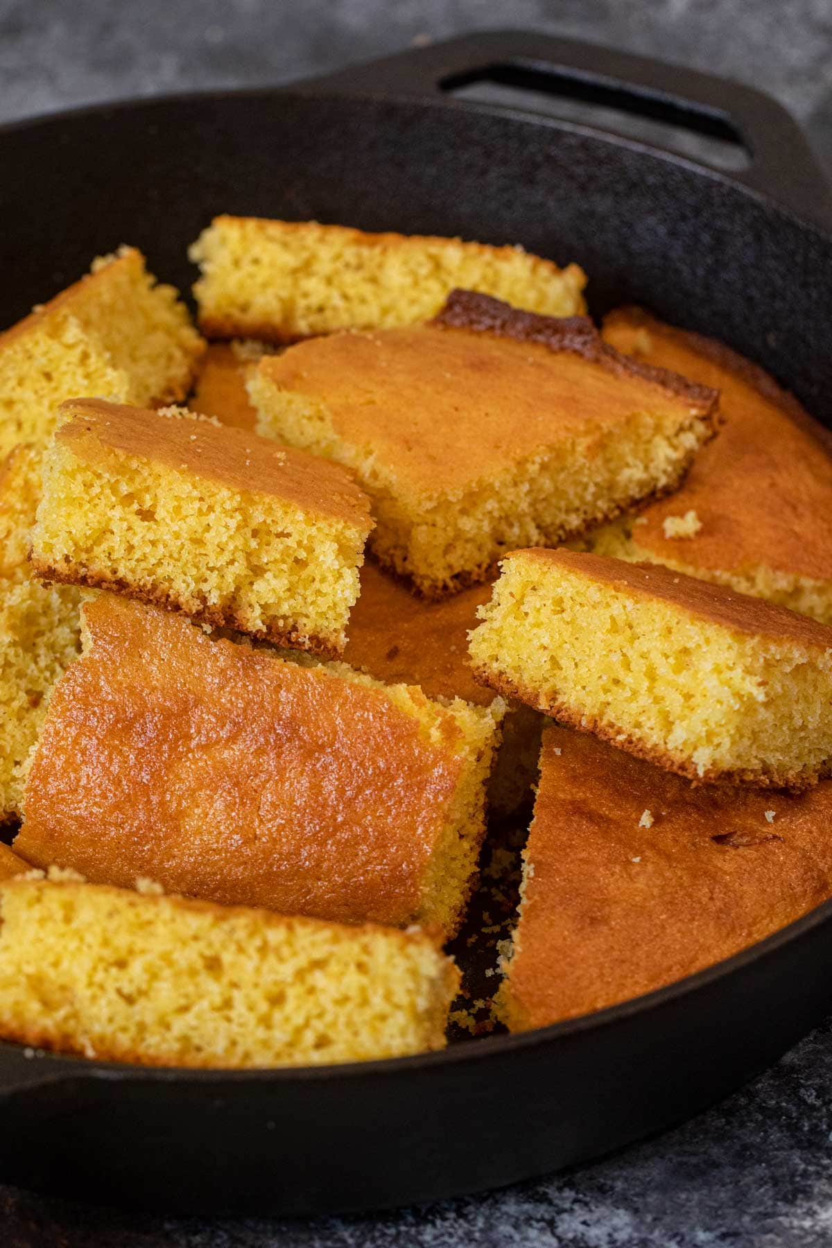 Skillet Cornbread sliced squares in cast iron skillet