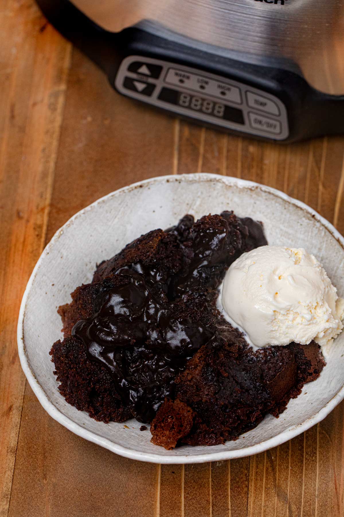 Slow Cooker Lava Cake in bowl with vanilla ice cream