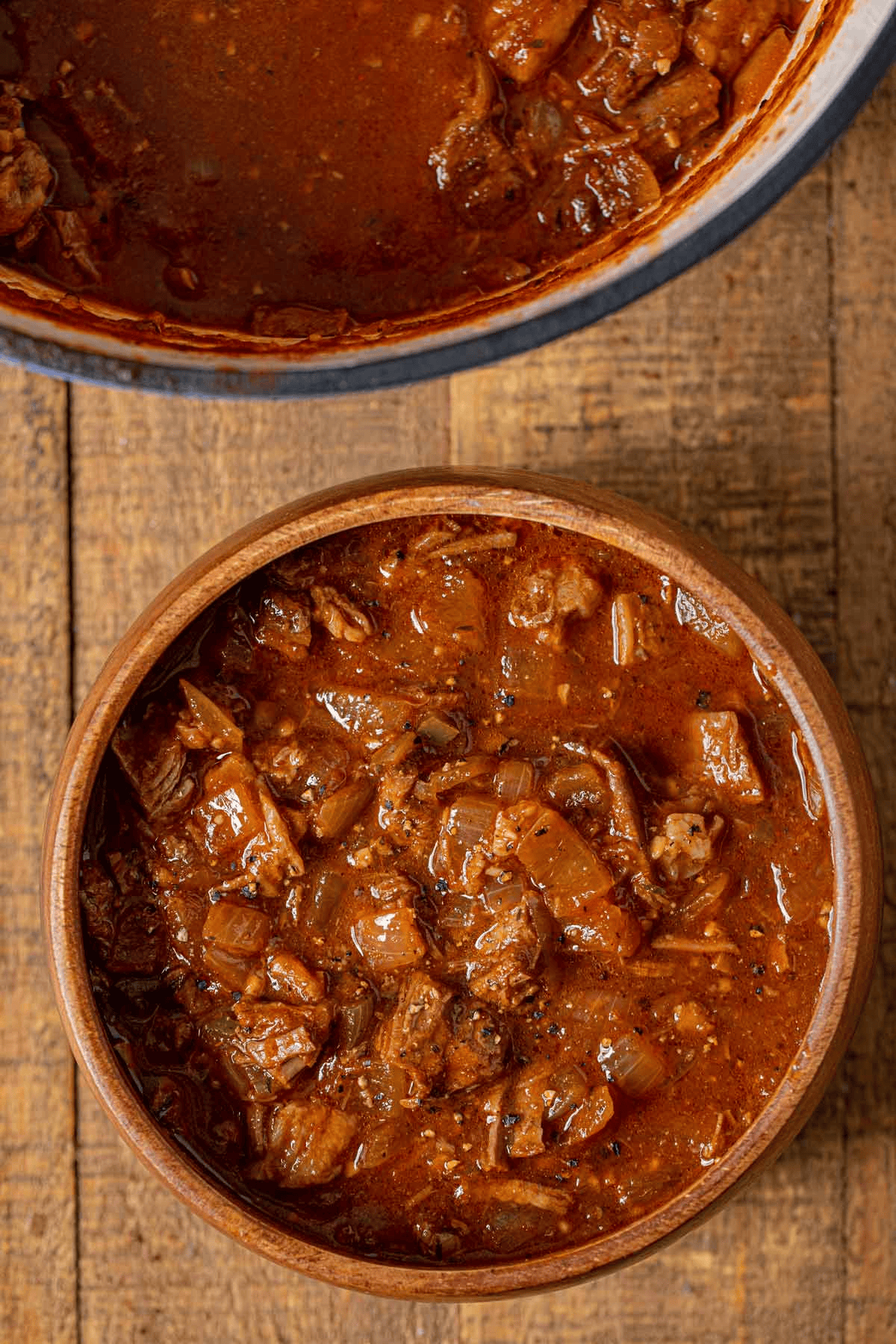 Bowl of chili next to a large pot