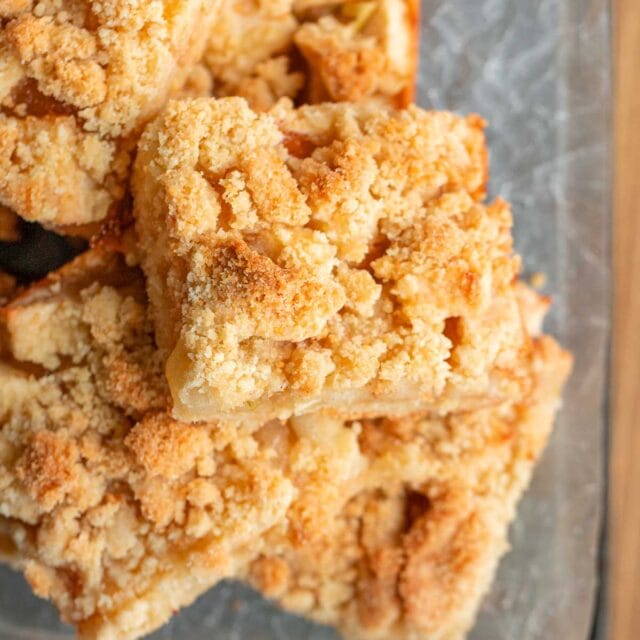 Sliced apple crumb bars stacked up