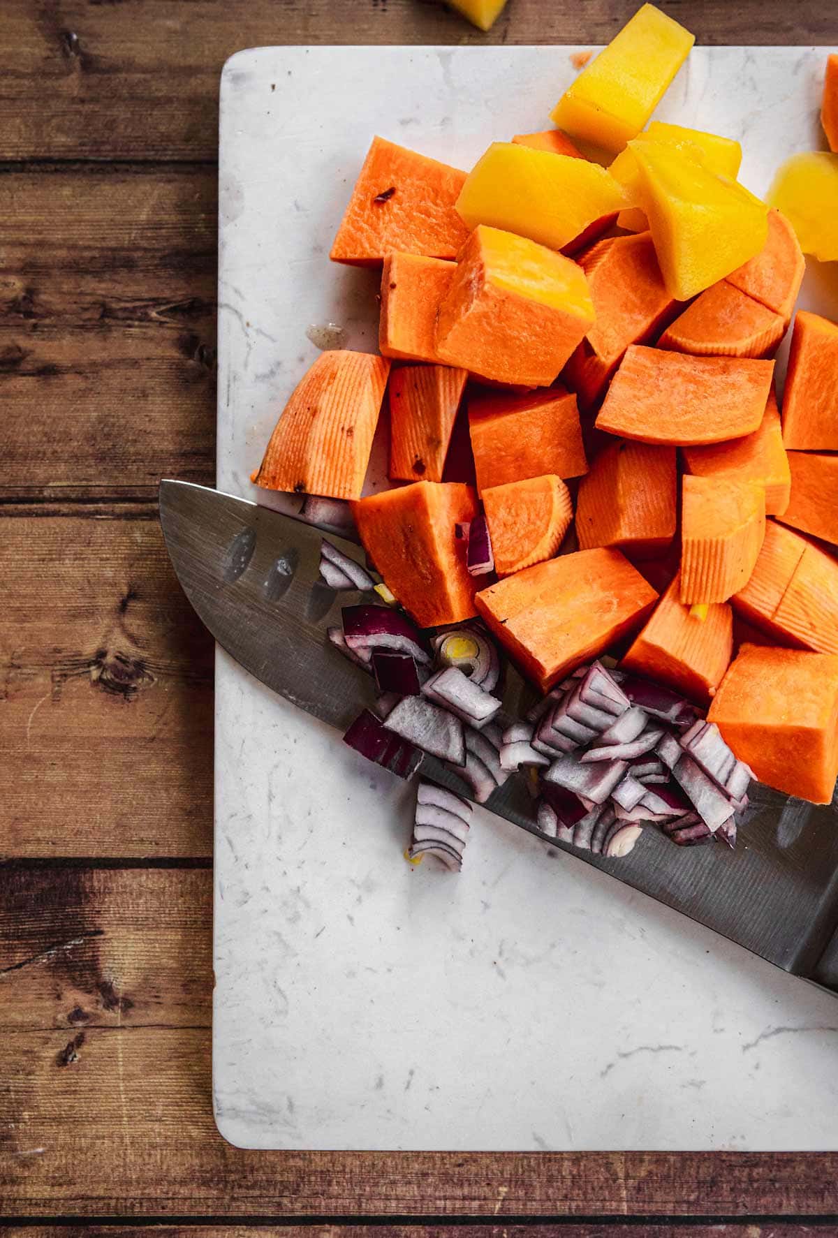 Baked African Sweet Potato Chicken chopped vegetables on cutting board