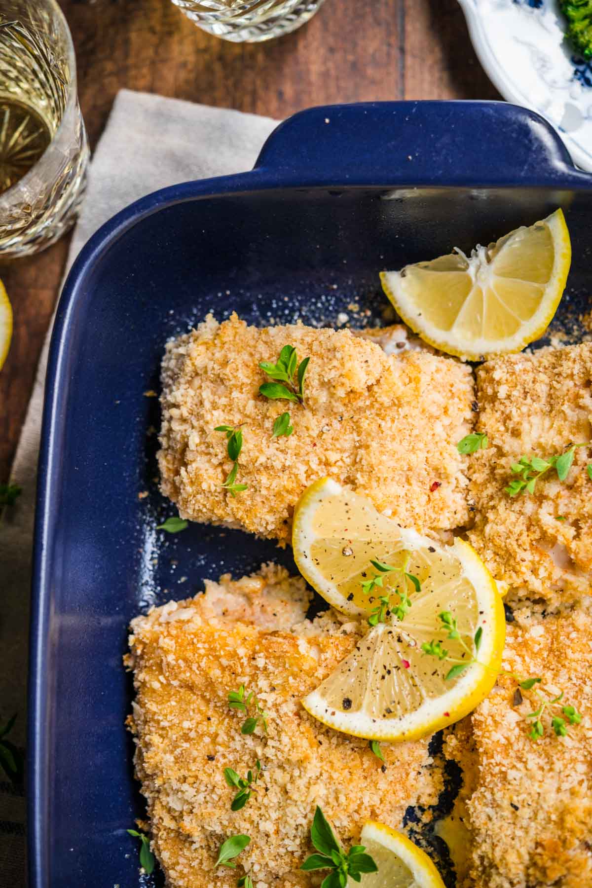 Baked Cod with lemon wedge garnish in baking dish