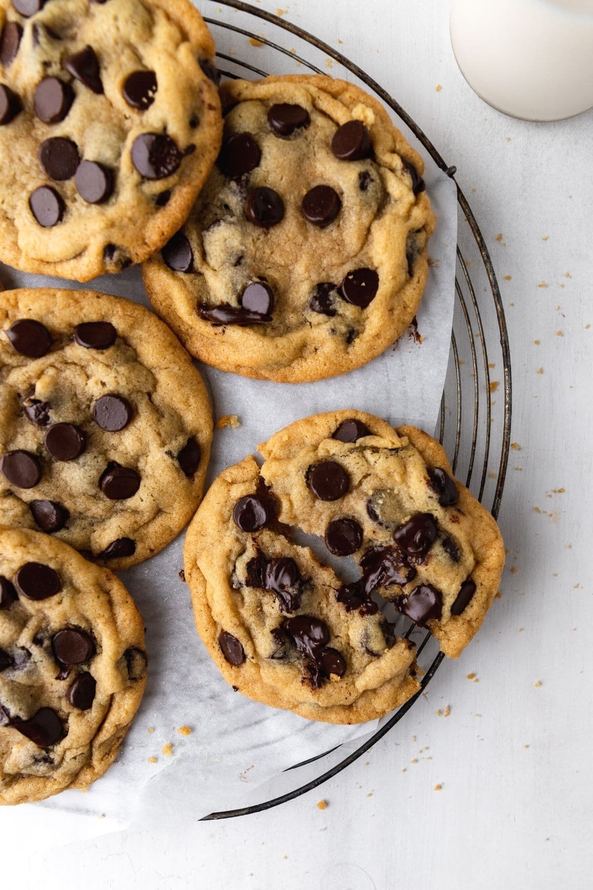 Bakery Style Chocolate Chip Cookies on cooling rack showing gooey chocolate