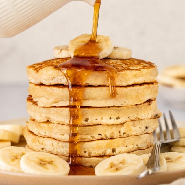 Banana Pancakes pouring syrup on stack 1x1