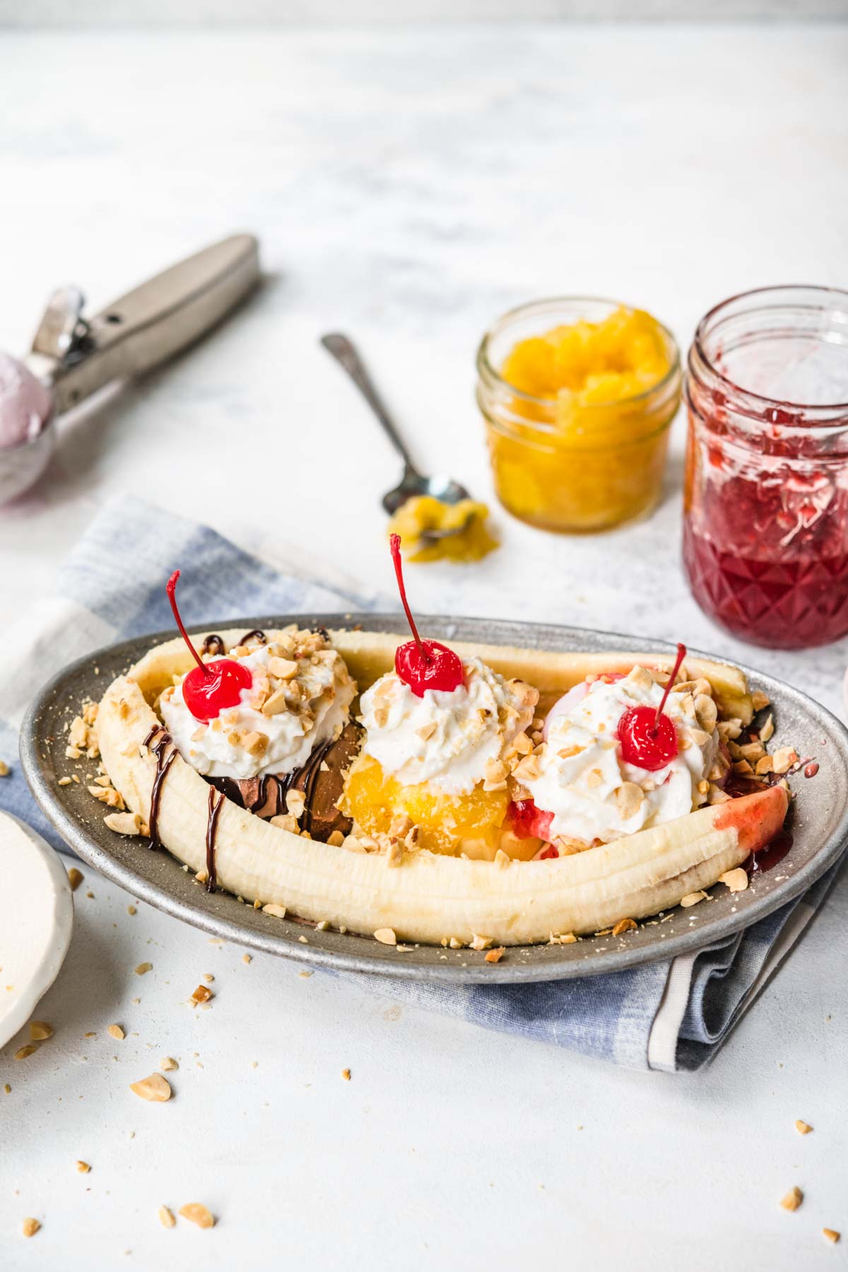 Banana Split on plate with chocolate, pineapple, and strawberry topping