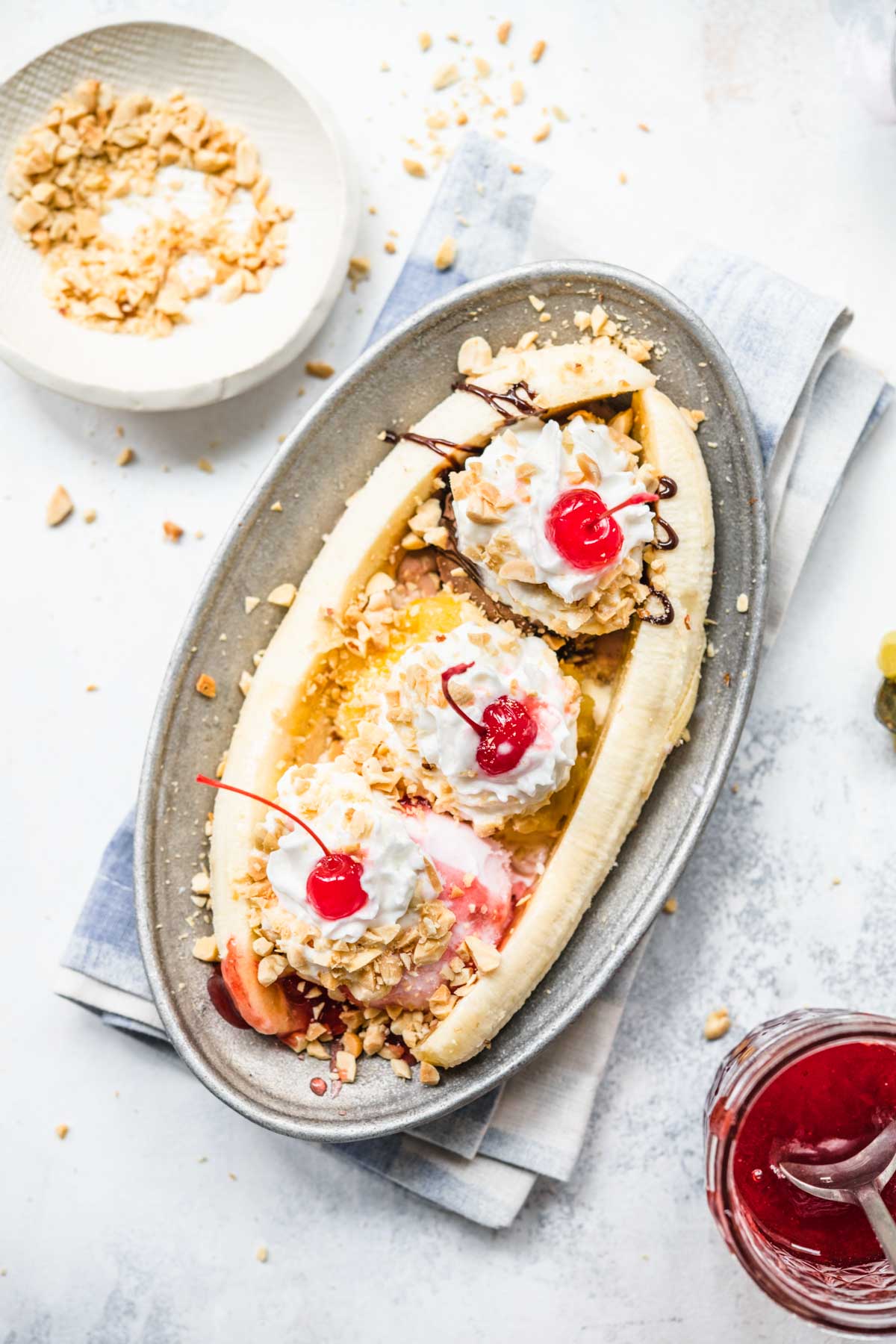 Banana Split on plate with chocolate, pineapple, and strawberry topping