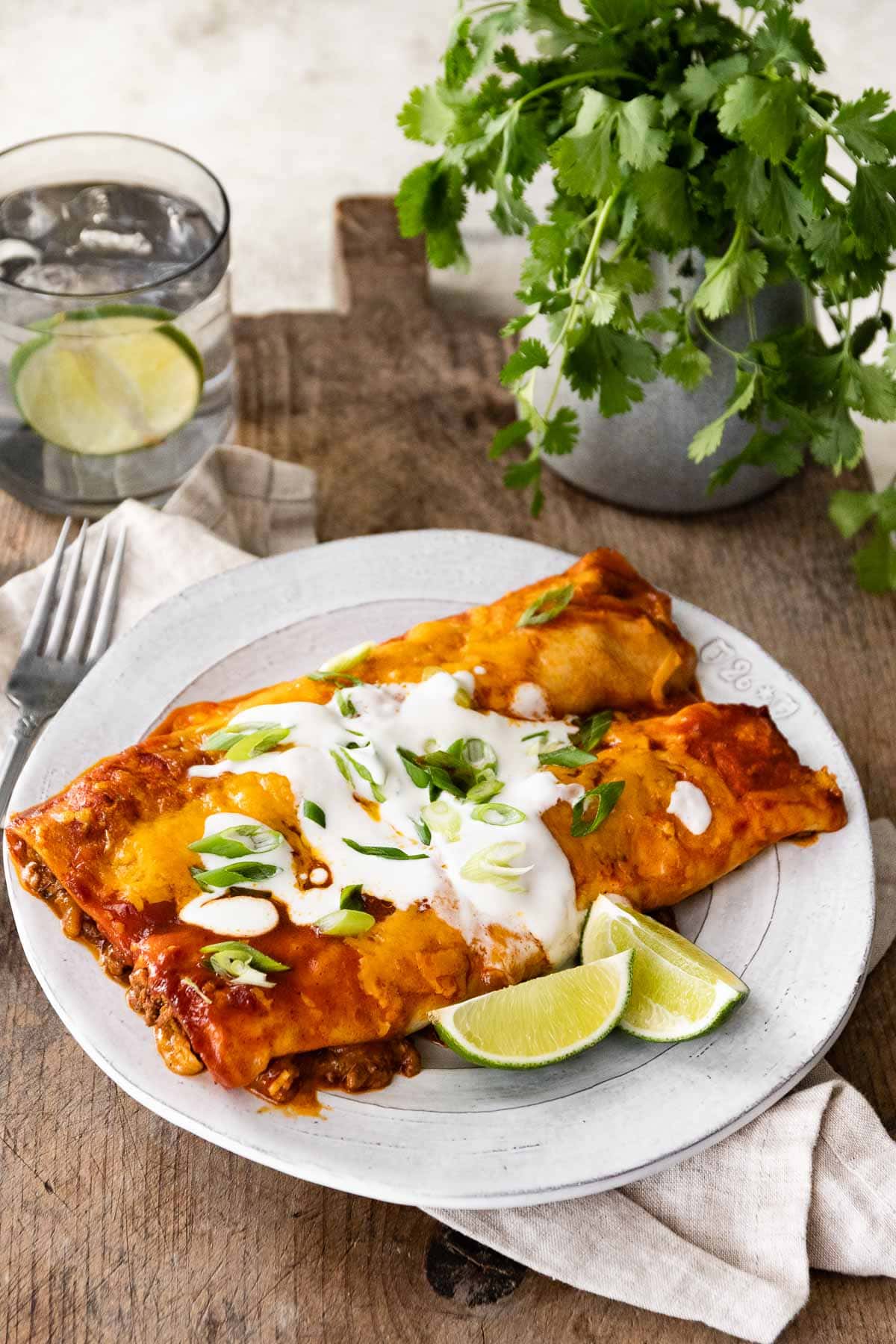 Beef Enchiladas on plate with lime wedges