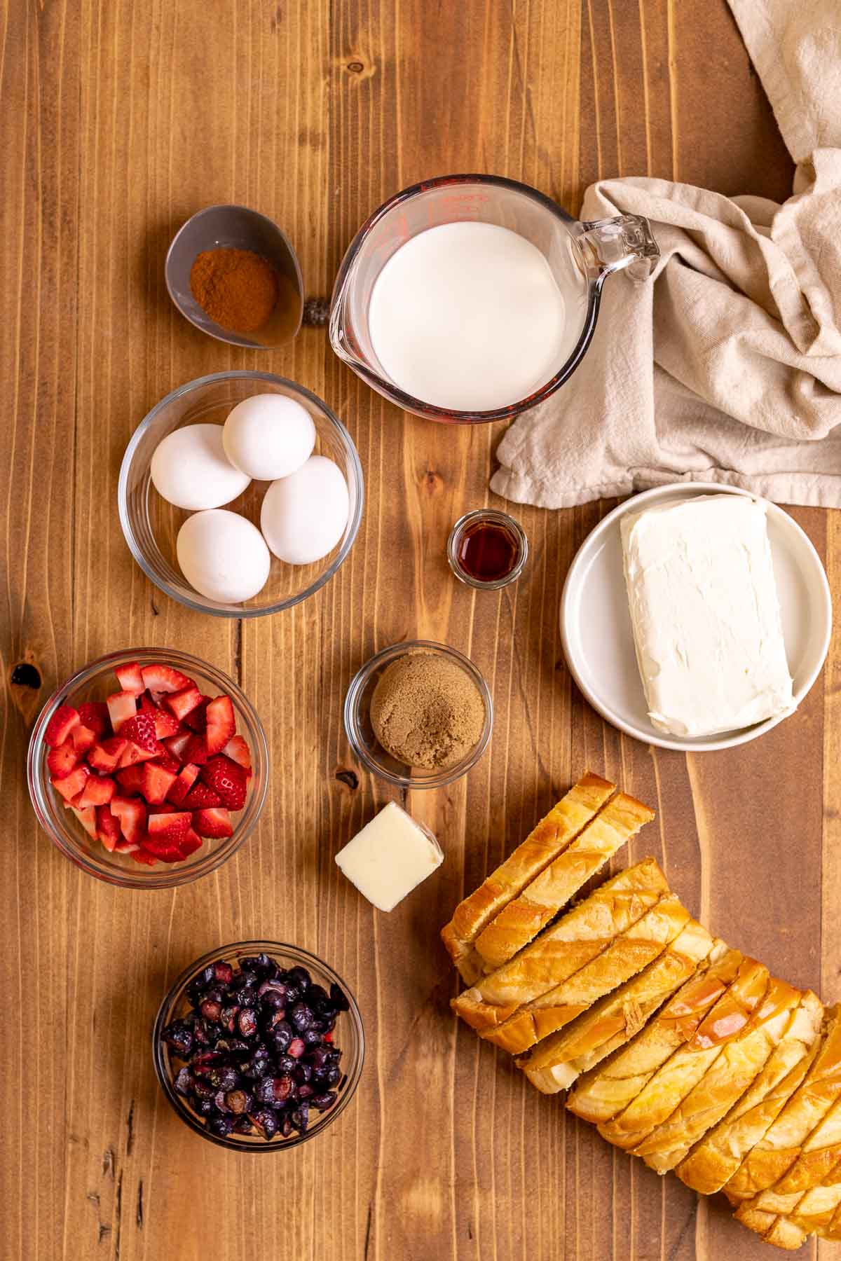 Ingredients for Berry Stuffed French Toast in prep bowls