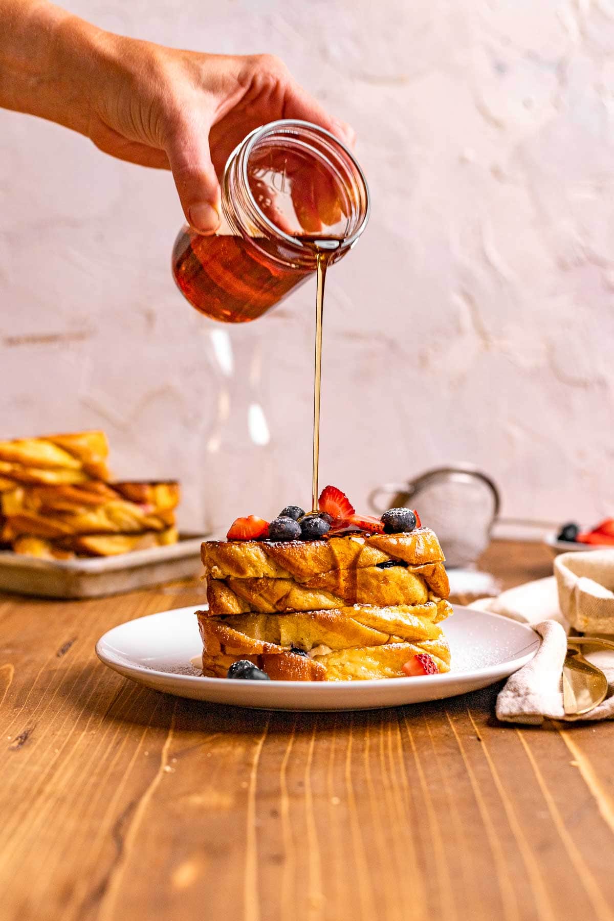 Berry Stuffed French Toast with maple syrup being drizzled