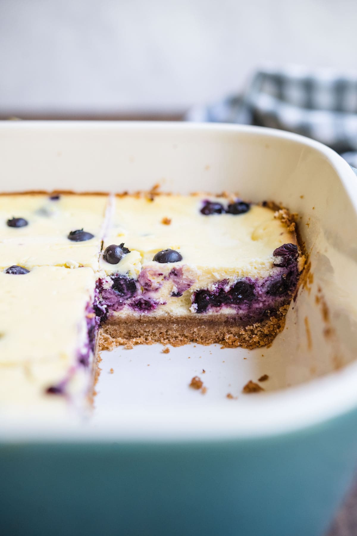 Blueberry Lemon Cheesecake Bars sliced in baking dish